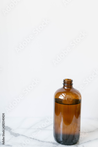 Amber Glass of Kombucha, Water Jug, Healthy Probiotic Drink, White and Marble Background, Copy Space