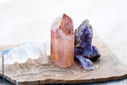 Lemurian crystal with Amethyst and Selenite Wand and Peacock  Rock.  Spiritual healing crystals for intentional meditation.  photo