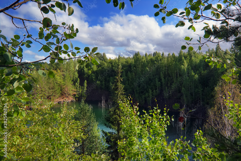 Summer landscape on the shore of a forest lake with clear transparent blue water. Sunset. Summer landscape on the shore of a forest lake with clear transparent blue water. Sunset.