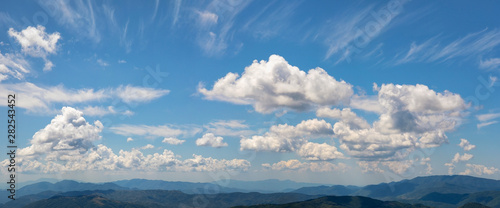 Horizon peaks and cloudy sky panorama.