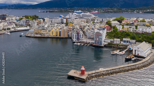 Alesund, Norway - July, 2019: Pier leading to the red lighthouse. Aerial view from above(drone shot)