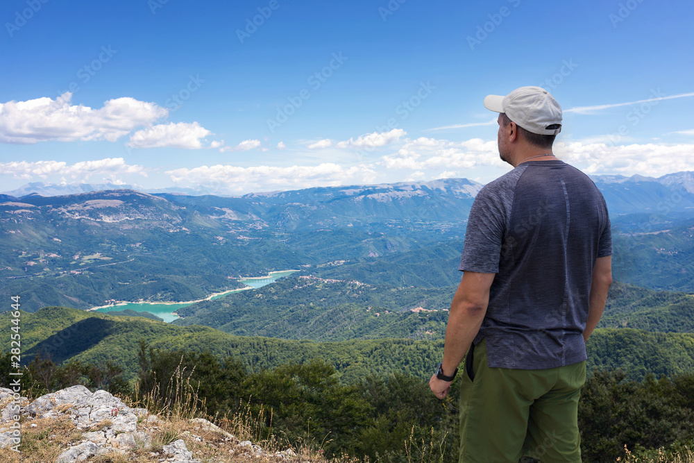 Mountain explorer observes the landscape on the horizon