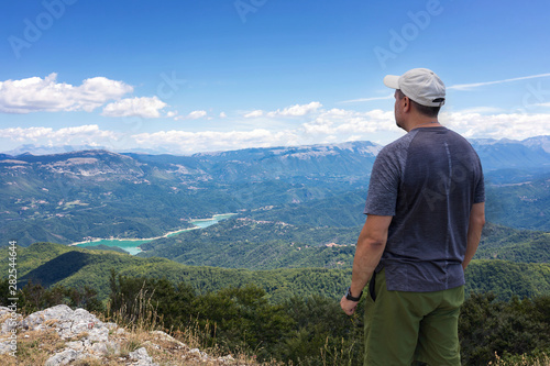 Mountain explorer observes the landscape on the horizon