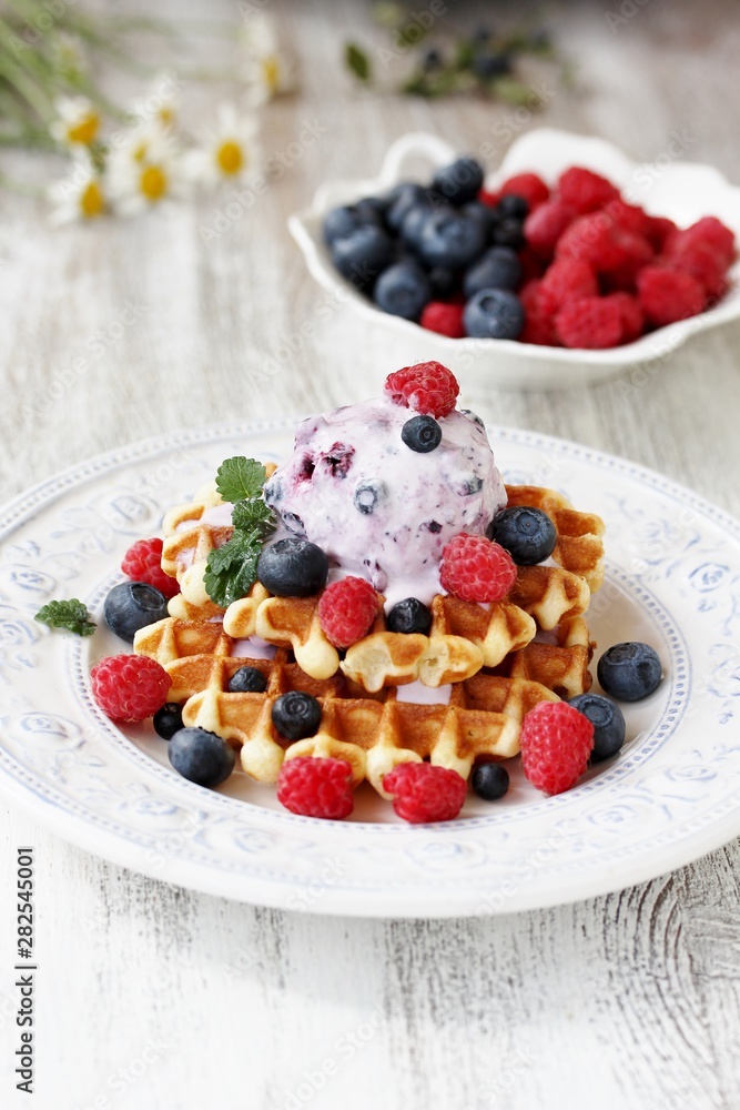 waffles with blueberries and raspberries and berry ice cream from yogurt. waffles with blueberries and raspberries and berry ice cream from yogurt.