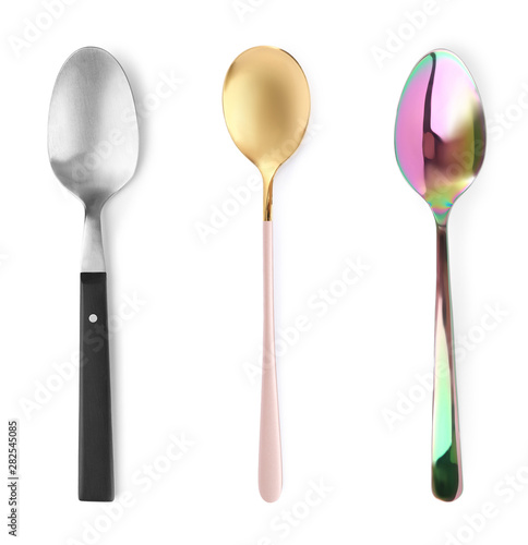 Set of different spoons on white background, top view