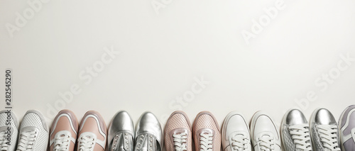 Flat lay composition with stylish shoes on light background. Space for text