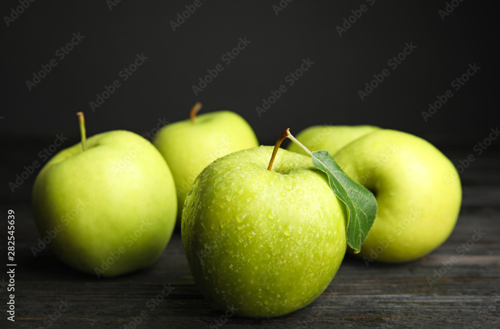 Fresh ripe green apples on black wooden table, space for text Fresh ripe green apples on black wooden table, space for text