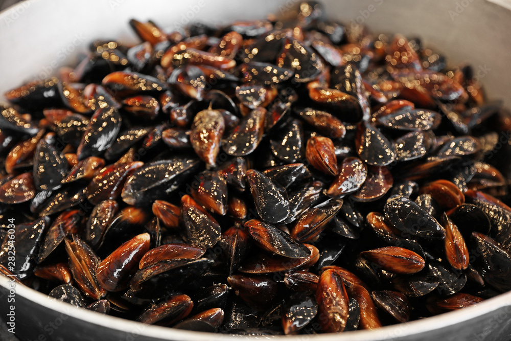 Many delicious fresh mussels in pan, closeup Many delicious fresh mussels in pan, closeup