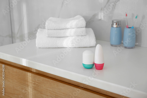 Different deodorants on light countertop in bathroom