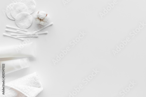 pattern of cosmetic cotton swabs, pads and cream on white background top view mockup