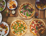 Pizza and other dishes on the wood table food style