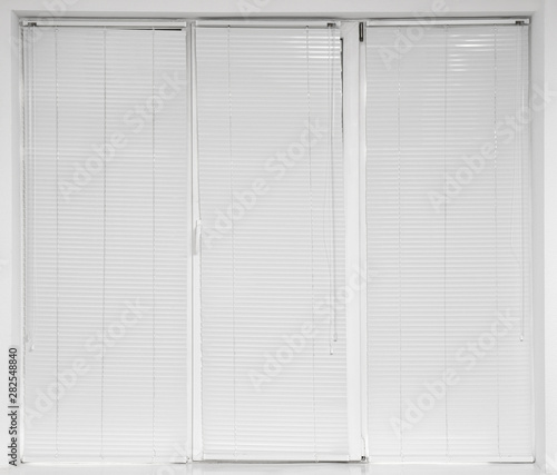 Window with closed modern horizontal blinds indoors