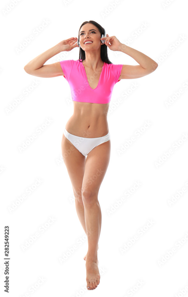 Beautiful young woman in stylish bikini with headphones on white background Beautiful young woman in stylish bikini with headphones on white background