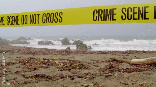 CRIME SCENE AT AN EMPTY, FOGGY BEACH.  NO PEOPLE.  4K, 10 BIT, 4:2:2 LOCK OFF SHOT.