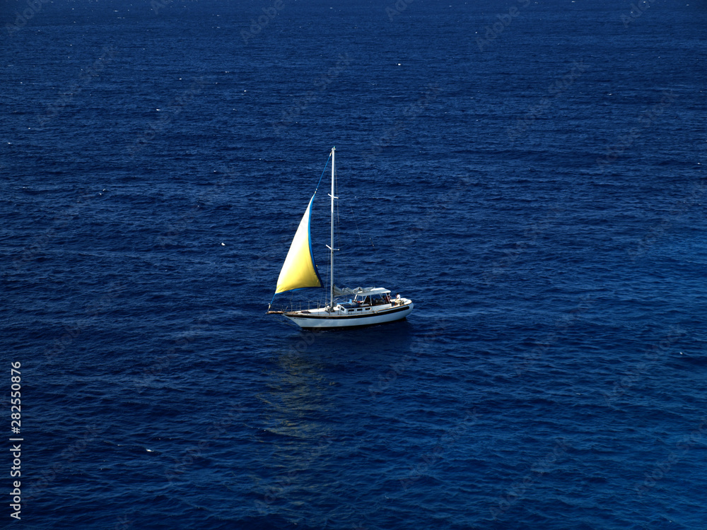 Sail boat shining in the ocean in Caribbean