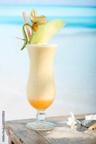 Single Glass of Pina Colada on the Beach. Sweet Cocktail Drink, Coconut Milk or Shake and Pineapple Juice.