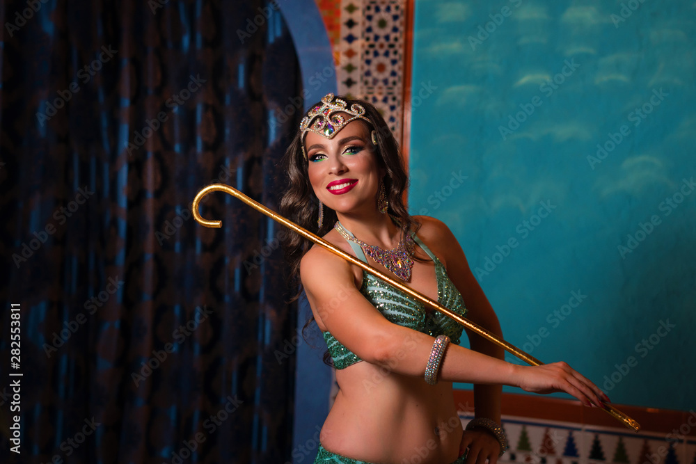 Oriental professional belly dancer in carnival shining costume with long  healthy glossy hair and cane. Exotic star of bellydance. Stock Photo |  Adobe Stock
