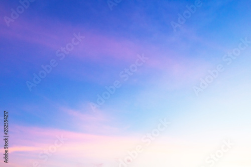 Abstract nature background of romantic pastel sky with silky & wispy cloud in golden hour time at spring evening. Beautiful puffy & fluffy clouds in bright blue sky in morning sunlight, copy space
