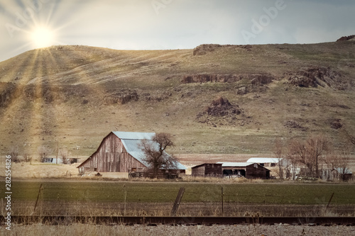 Sun Overlooking Farm Below the Hill