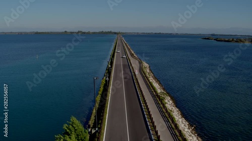 Wallpaper Mural Aerial drone shot of a long road surrounded by large bodies of water in Grado Italy Torontodigital.ca