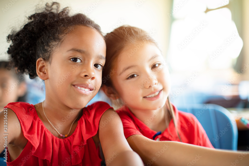 Smiling elementary school kids in classroom Smiling elementary school kids in classroom