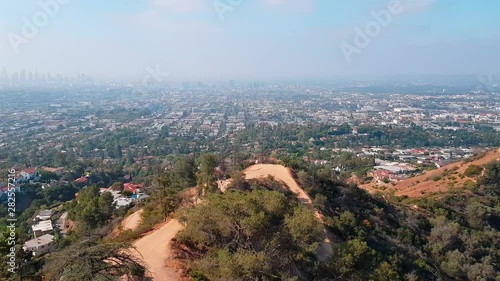 Panning shot overlooking LA from the Hollywood hills on a hazy day photo