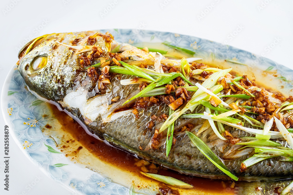 Chinese national dish steamed flower yellow croaker on white background