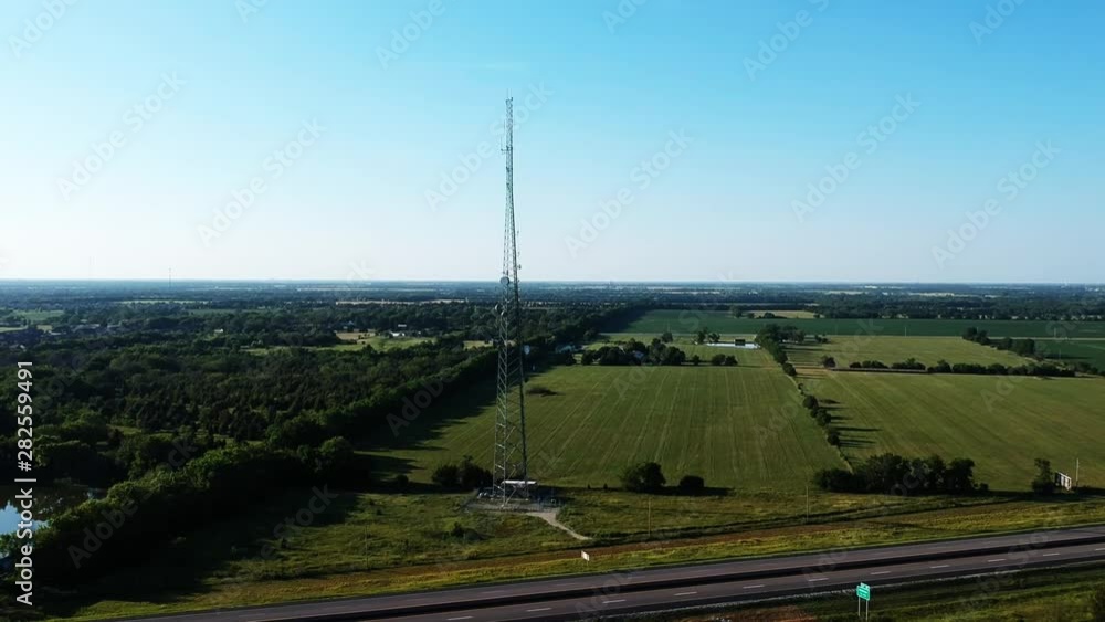 Rising Aerial Shot of Radio Tower Near Highway Rising Aerial Shot of Radio Tower Near Highway