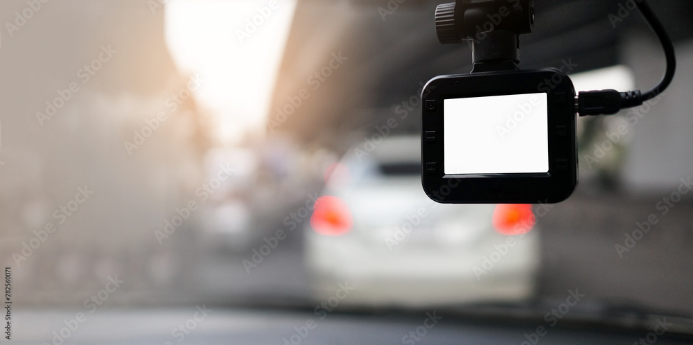 Dash Camera with white blank screen monitor with blurry background with space on the left