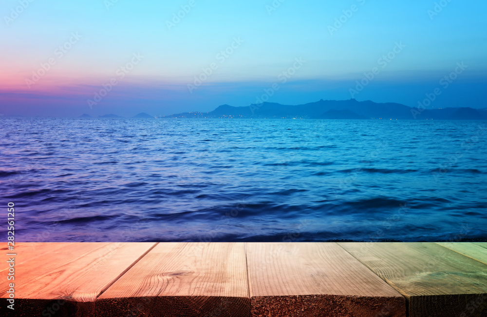 background of wood deck in front of sea landscape at sunset. ready for product display