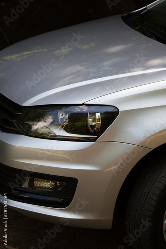 left headlight of a gray car © korvit