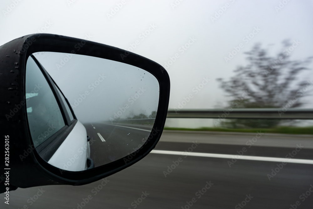 Car on the road with mirror reflection. Motion blur road.