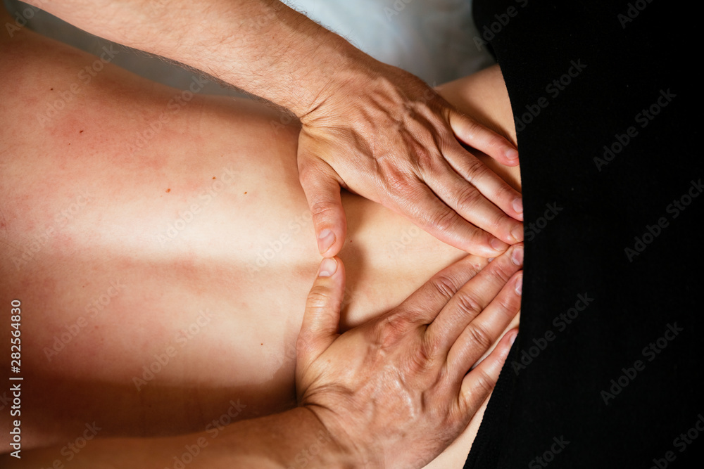 The hands of the specialist are making a massage in a massage room. Health concept The hands of the specialist are making a massage in a massage room. Health concept