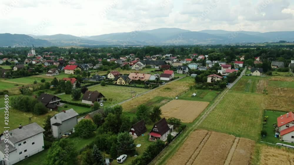 Aerial view of a small village with mountains in the background. Aerial view of a small village with mountains in the background.