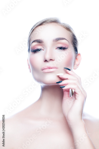 Beautiful modern young woman studio portrait woman with perfect skin, natural nude make-up, manicure, hand near face