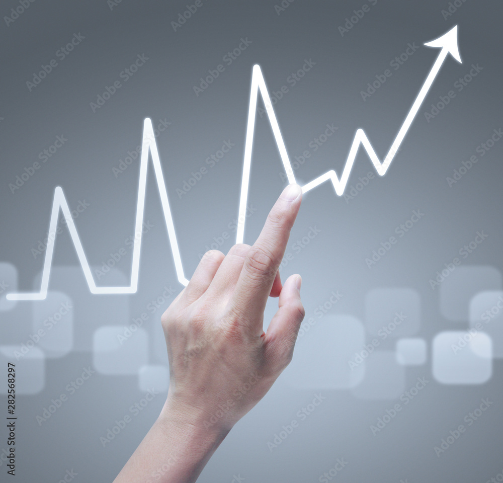 Hand touching graphs of financial indicator Hand touching graphs of financial indicator