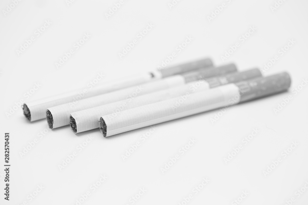 cigarettes stacked on a white background black and white photography cigarettes stacked on a white background black and white photography
