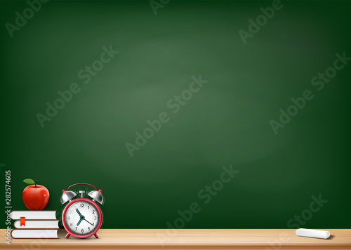 Background with blackboard books alarm clock and apple