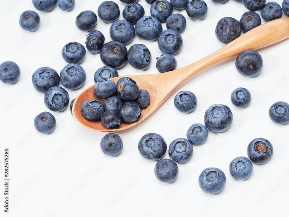 Blueberry fruit vitamins in a wooden spoon Blueberry fruit vitamins in a wooden spoon