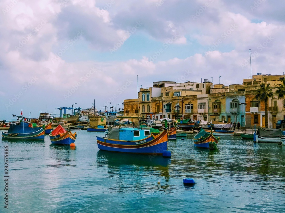 Traditional fishing boats Luzzu moored at Marsaxlokk Harbor, Malta