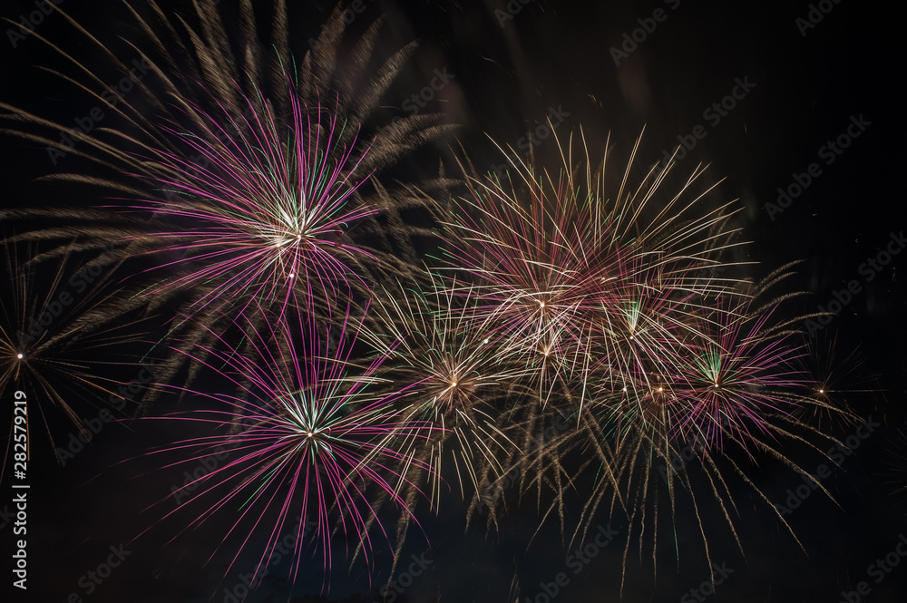 Colorful fireworks close up, fireworks explosion in dark sky. Free space for text. 
