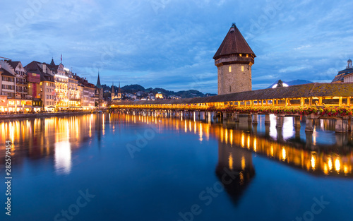 Old wooden architecture called Chapel Bridge in Luzern or Lucerne, Switzerland during sunset and twilight