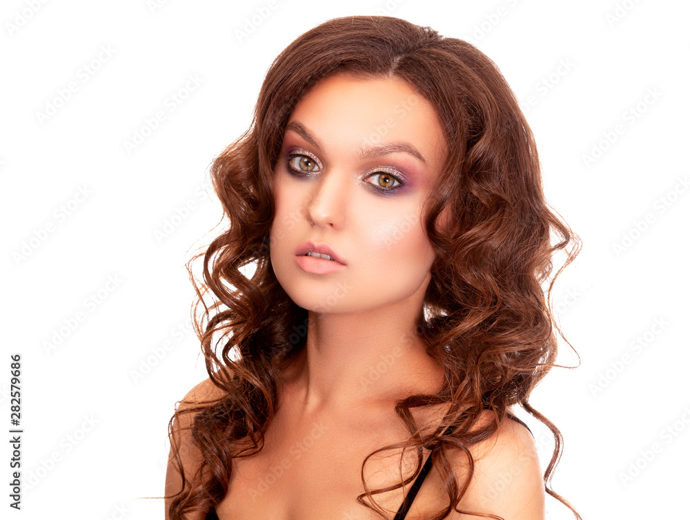 Pretty woman posing against white background. Makeup and hair style concept Pretty woman posing against white background. Makeup and hair style concept
