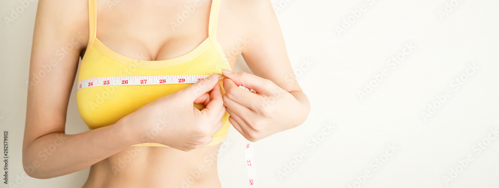 Measure chest. Close up of young beautiful Asian woman measuring