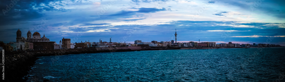 Sunset view to waterfront and Cathedral of Cadiz in Spain