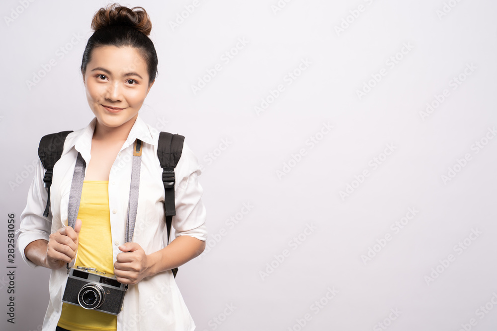 Happy woman holding camera over background and looking at camera Happy woman holding camera over background and looking at camera