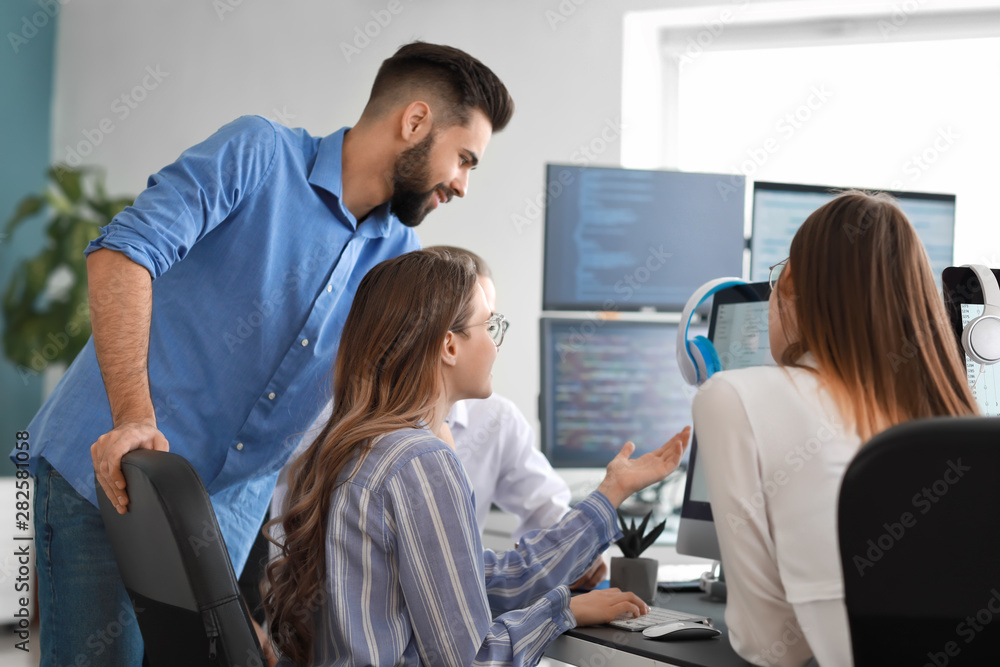 © Pixel-Shot - Team of programmers working in office