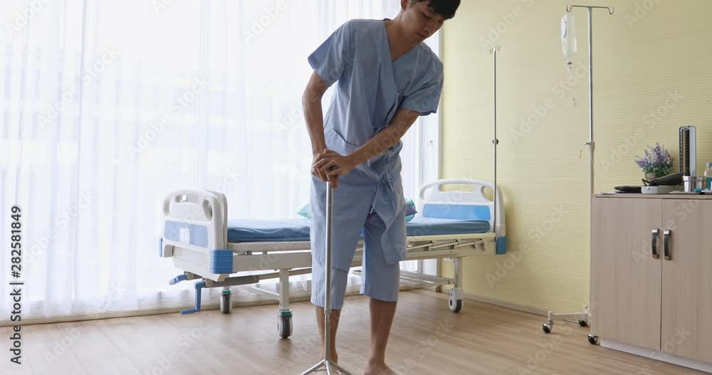 Handsome Asian male patient try to walking by crutch in hospital. Handsome Asian male patient try to walking by crutch in hospital.