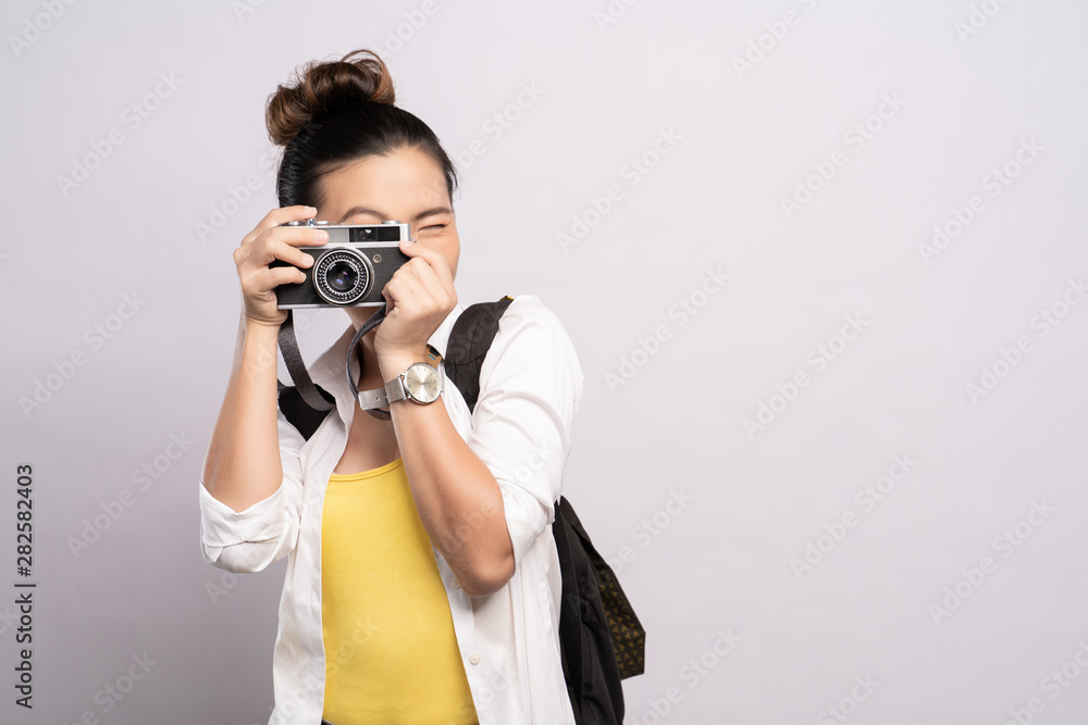 Happy woman take a photo by camera isolated over background