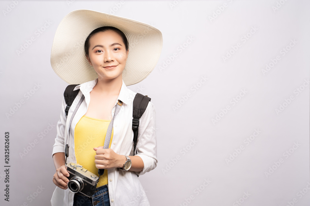 Happy woman holding camera over background and looking at camera Happy woman holding camera over background and looking at camera
